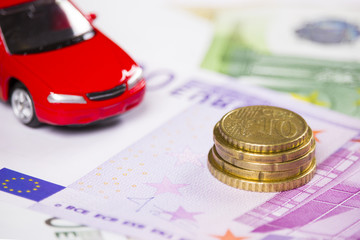 Euro banknotes and car model