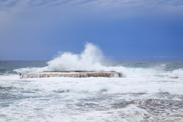 Waves crashing on rock