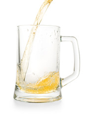 Light golden beer pouring into empty glass pint