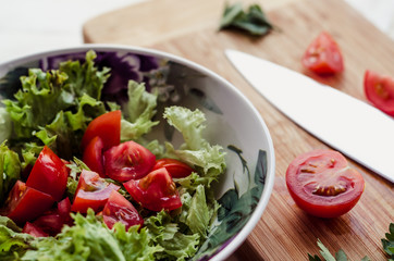 Vegetable salad in glass bowl on wooden table