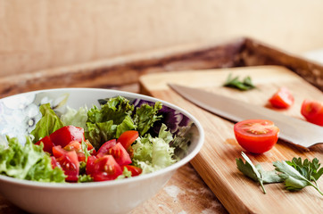 Vegetable salad in glass bowl on wooden table