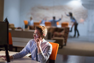 man using mobile phone in dark office