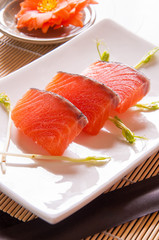 salmon sashimi on white dish on table background