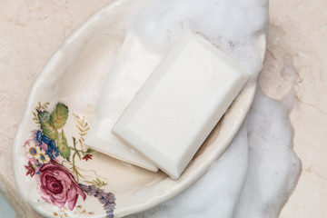 Soap bars in vintage soap dish with floral decor