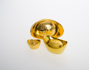 Gold or Chinese gold ingot mean symbols of wealth and prosperity on a background.