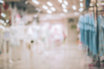 Shopping center with customers and seasonal sale promotions. Blurred, people unrecognizable