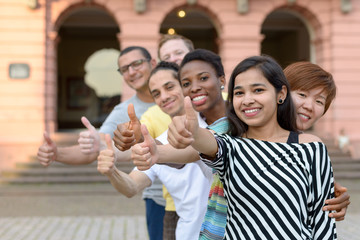Group of young people with thumbs up