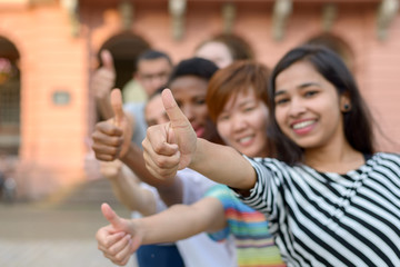 Group of young people with thumbs up