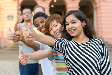 Group of young people with thumbs up