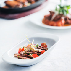  sliced beef with vegetable garnish