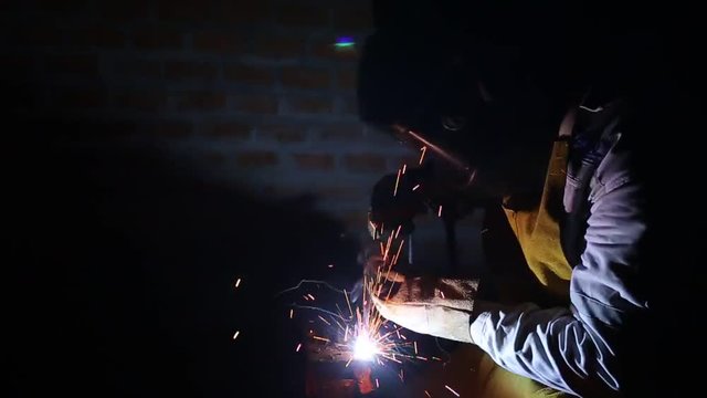 Man worker welding steel dolly slider footage