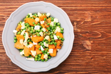 Warm salad with roasted pumpkin, peas and cheese brie