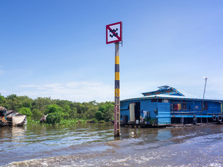 Boat traffic sign at Tonle Sap, Siem Reap, Cambodia, caution about not creating high wave in community district by controlling the speed of the boat