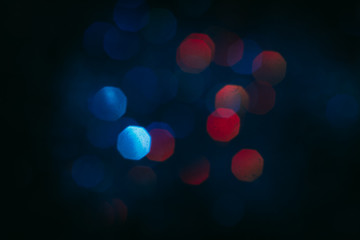 Abstract blurred glittering shine, teal and red. Blur light bokeh, night background. Christmas wallpaper decorations concept. New year holiday festive backdrop. Sparkle circle celebrations display.