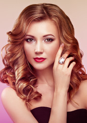 Fototapeta premium Blonde woman with long and volume shiny wavy hair . Beautiful model with curly hairstyle. Perfect make-up. Beauty style model