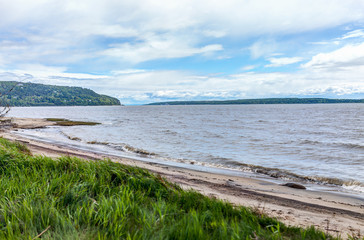Baie-Saint-Paul in Quebec, Canada beach shore and coast with waves and green grass