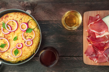 Spanish tortilla in tortillera, with wine, jamon, and cheese
