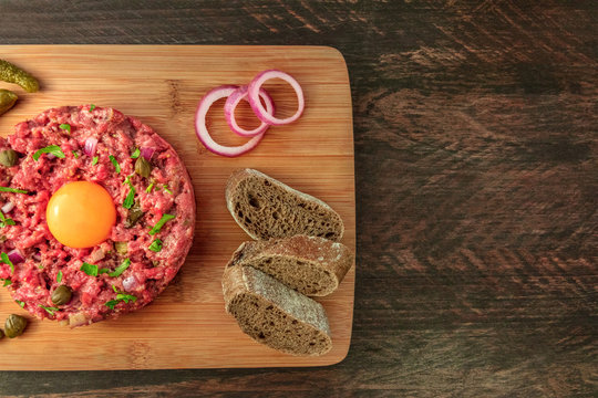 Closeup of steak tartare with garnish, and copyspace