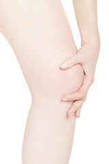 Woman touching her painful kneecap isolated on white, clipping path