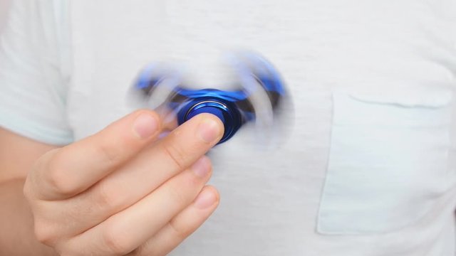 Man holding and playing with fidget spinner