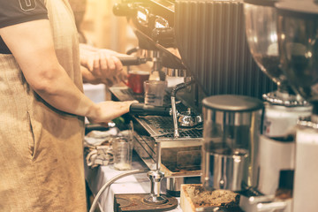 Barista people making coffee with coffee machine in the cafe.