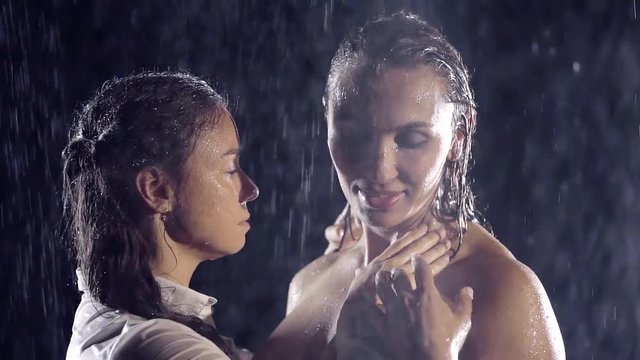 Homosexual couple, gay, young lesbians, same-sex marriage relationship between the happiest girl in the shower stall. Naked sexy lesbians enjoy caressing, under the jets of water in the dark