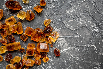 lumps of brown sugar for sweets on kitchen table background top view mock up