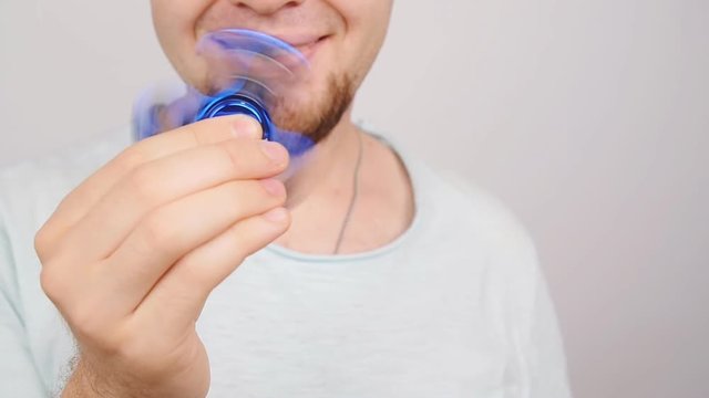 Man holding and playing with fidget spinner