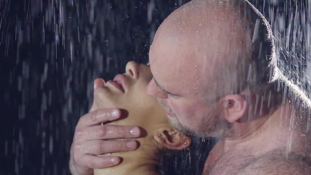 young woman and young man in the shower. naked wet bodies. bald brutal man with hairy body