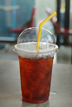 Plastic glass of cold iced black tea.