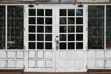 Old locked white door house.