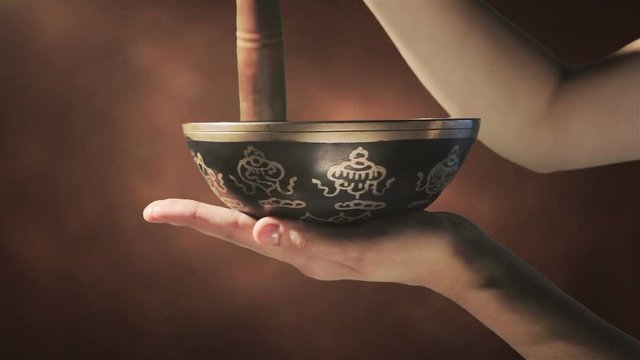 Tibetan singing bowl music meditation by ringing with a wooden handle on the bowl  with healing vibration and mantra which is  is translate - Oh the pearl shining in the lotus flower