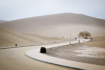 Fototapeten The road inside Mingsha shan desert and Crescent moon lake in Dunhuang, Gansu, China © grafixme