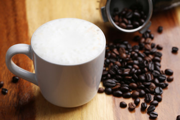 Hot latte , hot coffee and milk foam on wood floor