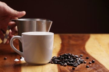 Hot latte , hot coffee and milk foam on wood floor