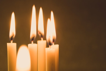 Group of still life  golden candle light with reflection on soft red blurred  background. Abstract background for pray or meditation caption and hope concept