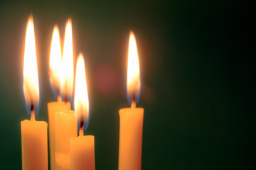 Group of still life  golden candle light with reflection on soft green blurred  background. Abstract background for pray or meditation caption and hope concept