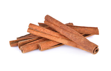 pile of dried cinnamon on white background