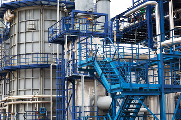 Close-up of pipelines and destillation tanks of an oil-refinery plant