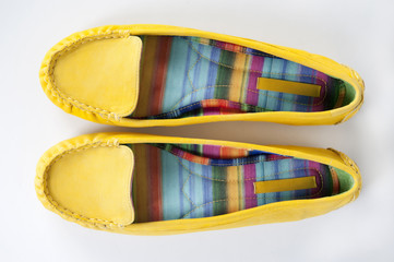 Beautiful yellow women shoes isolated on white background