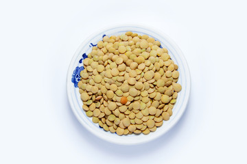 Top view of a lentils in white small dish isolated on white background