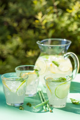 refreshing lemonade drink with mint lime lemon in garden