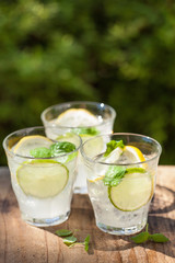refreshing lemonade drink with mint lime lemon in garden