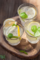 refreshing lemonade drink with mint lime lemon in garden
