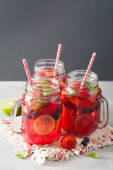 summer berry lemonade with lime and mint in mason jar