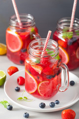 summer berry lemonade with lime and mint in mason jar