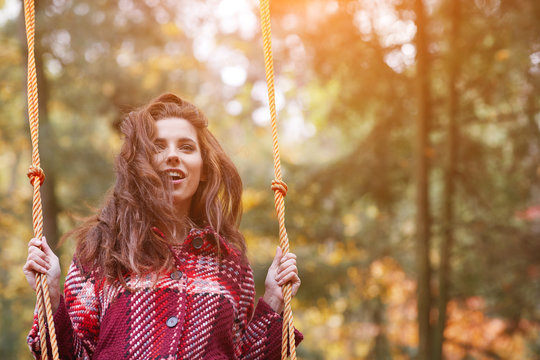 Woman On A Swing In An Autumn Park