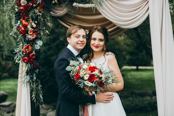 Stunning wedding couple on the wedding ceremony at the autumn