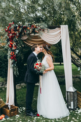 Beautiful wedding couple on the wedding autumn ceremony