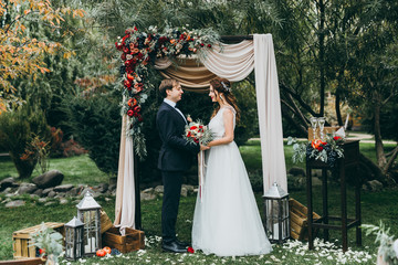 Beautiful wedding couple on the wedding autumn ceremony